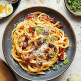 Un plato de espagueti con carne y queso.