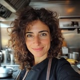 A woman with curly hair and a smile.